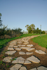 Village flat stone path next to grass 