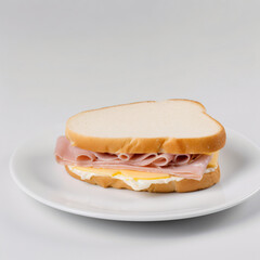 ham and American cheese sandwich with mayo on white bread served on a plain white appetizer plate