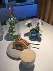 photo of a table served with coffee dessert flowers and bottle water. High quality photo