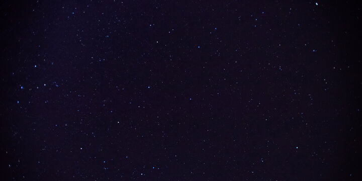 Panorama blue night sky milky way and star on dark background.Universe filled with stars, nebula and galaxy with noise and grain.Photo by long exposure and select white balance.Dark night sky.