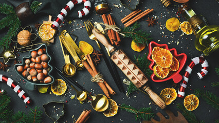 Christmas photo background with a set of ingredients for cooking and baking. Christmas tree, winter spices and kitchen utensils.