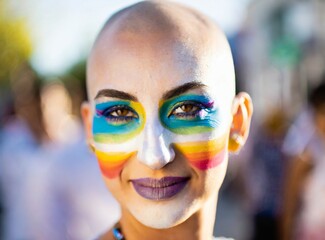 Gay woman with rainbow makeup face closeup