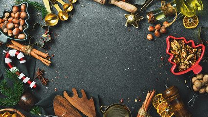 Christmas photo background with a set of ingredients for cooking and baking. Christmas tree, winter spices and kitchen utensils.