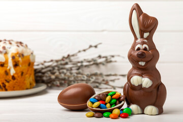Easter chocolate bunny on a light texture table. Chocolate eggs and other sweets. Easter...
