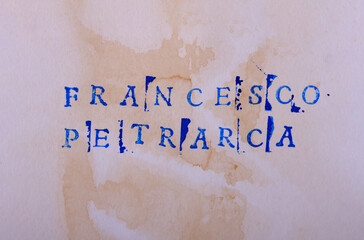 The name of the classic Italian poet Francesco Petrarca (1304 - 1374) is written in stamped letters...