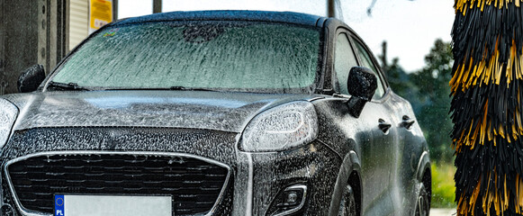 A vehicle in an automatic car wash