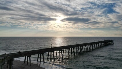 Beautiful sunset over a pier in the sea.