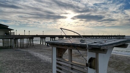 Fototapeta premium Beautiful sunset over a pier in the sea.