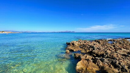 Rocky coast under a blue sky.