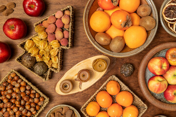 Selection of nuts and fruits on a table. Healthy snacks. Top view.