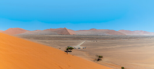 Fototapeta na wymiar A panorama view from Dune 45 in strong winds in Sossusvlei, Namibia in the dry season
