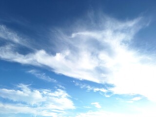 Naklejka na ściany i meble Beautiful blue sky with white clouds for background