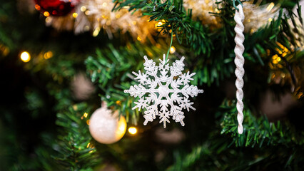 Adorned with holiday snowflake, a festive Christmas snow flake hang on the tree