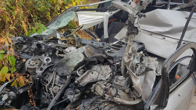 A completely wrecked car after a traffic accident.