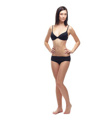 Fototapeta premium Young woman, portrait and full body in underwear to lose weight, slim or diet against a white studio background. Attractive female person or model posing in lingerie for health and wellness on mockup