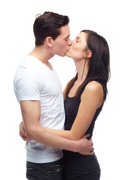 Happy couple, kiss and hug with love in studio mockup, romance and care in committed relationship for bonding. Young man, woman and date for marriage loyalty, support and together by white background