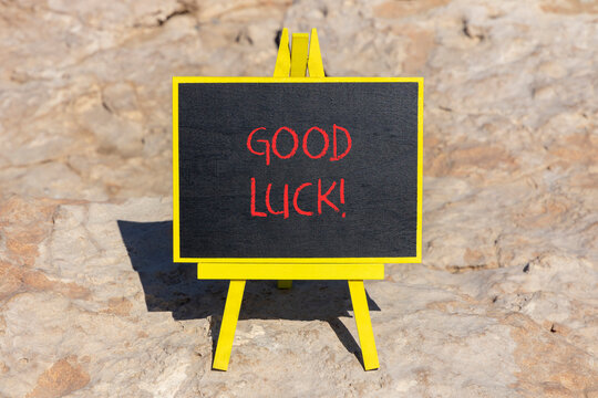 Good luck symbol. Concept words Good luck on beautiful black chalk blackboard. Beautiful sea stone beach background. Business, motivational good luck concept. Copy space.