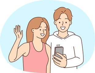 Smiling couple talking on video call on cell