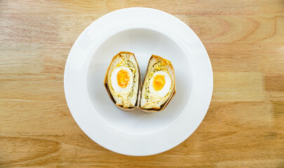 A boiled egg with egg mayonnaise cabbage with bread  sandwich 