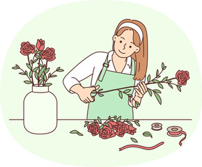 Female florist working with flowers in workshop