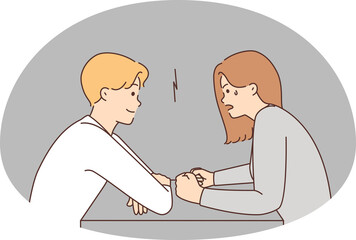 Couple with different moods sit at table