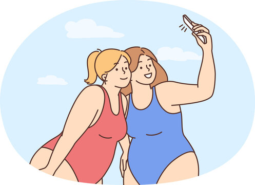 Overweight women in bikinis make selfie