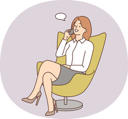 Smiling businesswoman in chair talking on cell