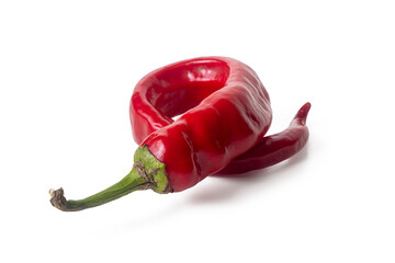 Twisted pod of hot red chili pepper on a white background