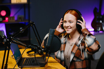 Portrait of a girl who hosts a night broadcast. An online blogger is recording a new episode for his channel in his home studio.