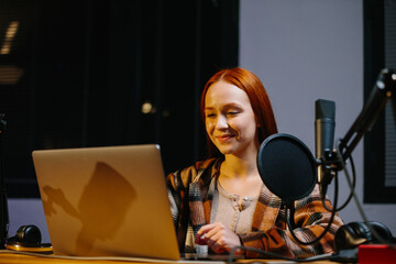 Portrait of a girl who hosts a night broadcast. An online blogger is recording a new episode for...