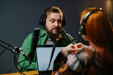 Radio presenters communicate live. The presenter and his guest have a conversation during the...