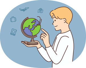 Smiling boy play with globe