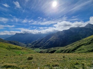 Fototapeta na wymiar Beautiful landscape of green hills under a blue sky with clouds in Asturias, Spain.