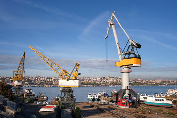 Large industrial cranes in the port at the shipyard for the repair of boats.