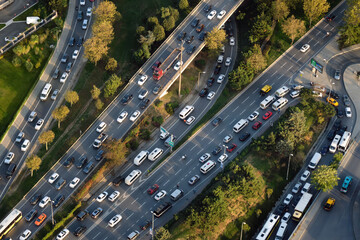 Aerial view of several multi-lane highways of different levels. Lots of cars, buses and trucks.