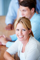 Fototapeta premium Woman, portrait and smile in team meeting, office and collaboration or teamwork, workshop and seminar. Happy people, confidence and positive mindset at company, future and growth or face in boardroom
