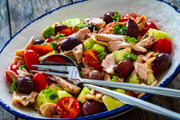 Tuna greek salad on wooden table

