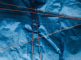 Blue crumpled synthetic fabric.
