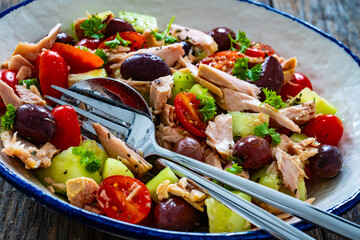 Tuna greek salad on wooden table
