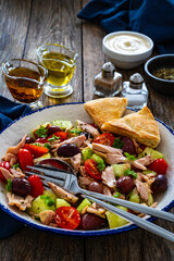 Tuna greek salad on wooden table
