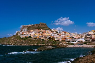 Fototapeta na wymiar colorful buildings lining a coastal shoreline line near the ocean and cliffs