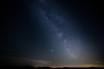 Fototapeta na wymiar Breathtaking view of a starlit night sky, with the Milky Way, illuminated in all its majestic glory