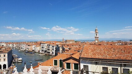 Beautiful view of red roofs of the buildings and the channel of the Venice city in summer