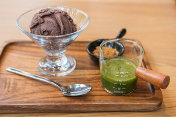 Affogato chocolate ice cream with green tea hot fudge on wood table