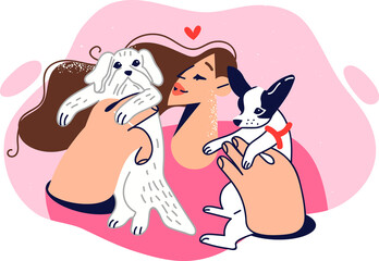 Woman plays with two puppies, showing love and care for small dogs adopted from shelter