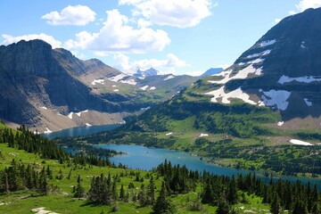 Fototapeta na wymiar Glacier National Park with Hidden Lake flowing by the lush evergreen trees