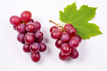 Fototapeta premium Half-sliced red grapes with verdant foliage isolated on a pristine backdrop, viewed from above.