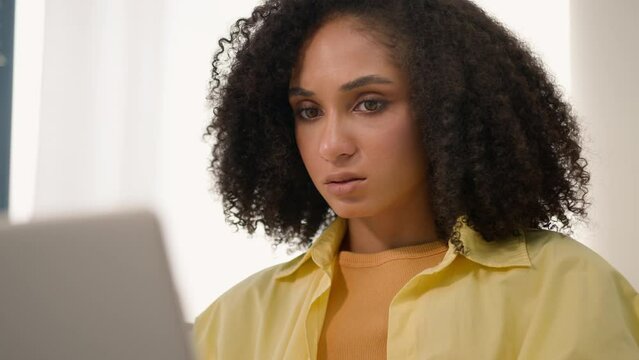 African American shocked woman businesswoman sad anxious business girl confused negative bad emotion notification on laptop computer app problem lost stunned amazement shock failure loss money at home