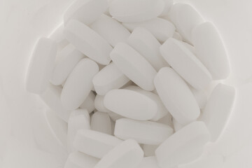 Magnesium tablets are white in a jar
