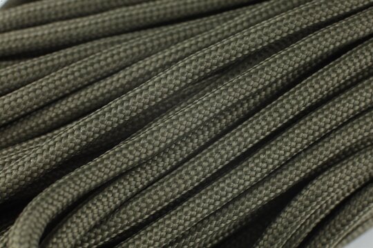 Olive-colored paracord cord. A skein of lace.